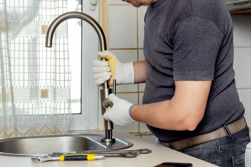 Handyman Fixing a Leaking Faucet